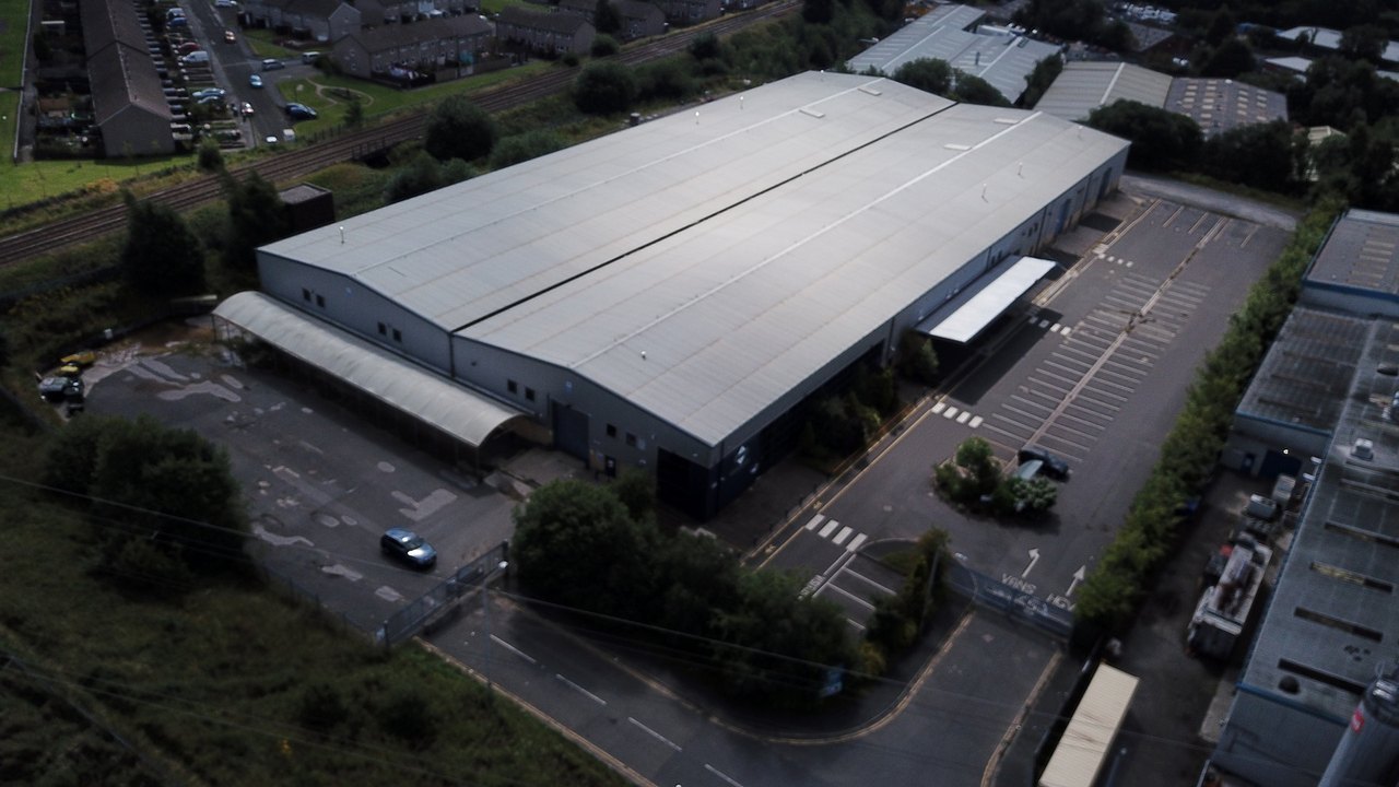 Aerial of a large industrial building and yards at Britannia Way, Bolton.