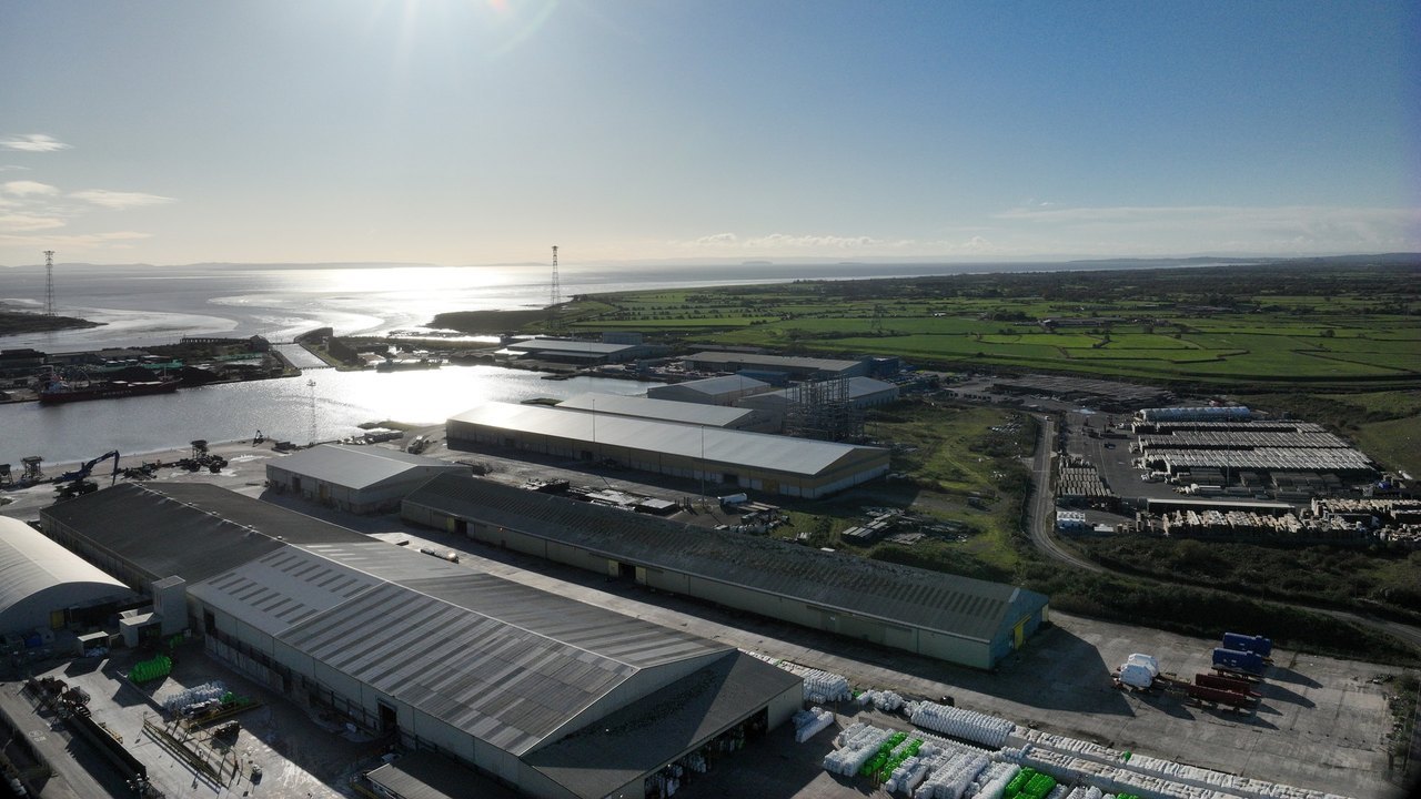 Aerial of warehouses, yards and dock water at Newport.
